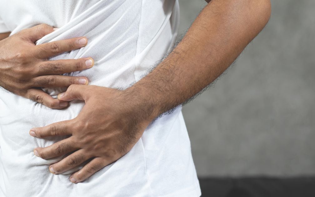 Cannabis Crohn's Disease-man-with-stomach-ache-hands-holding-touching-his-stomach